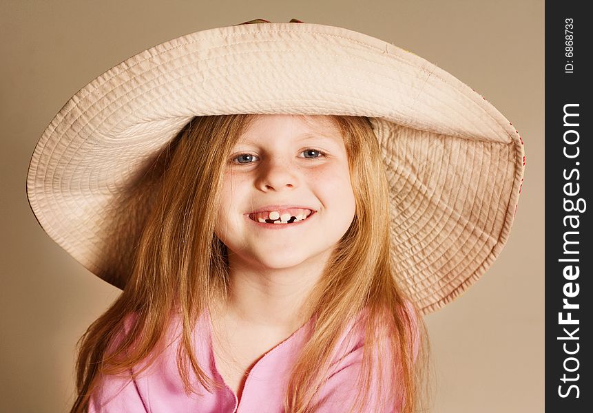 Small smiling girt wearing a hat in pink dress. Small smiling girt wearing a hat in pink dress