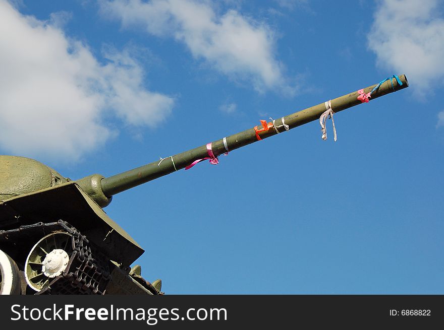 Fragment of warriors - tankmen monument of World War 2 with blue sky and clouds used as totem for newly-weds :). Fragment of warriors - tankmen monument of World War 2 with blue sky and clouds used as totem for newly-weds :)