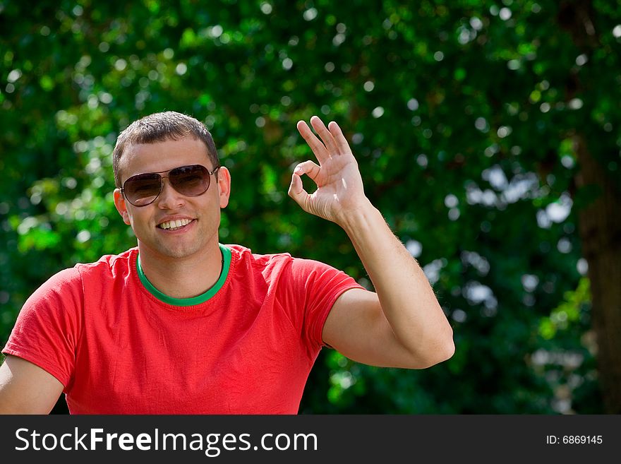 Young smiling man giving OK gesture. Young smiling man giving OK gesture