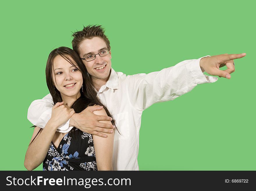 Couple looking at imaginary point over green screen. Couple looking at imaginary point over green screen