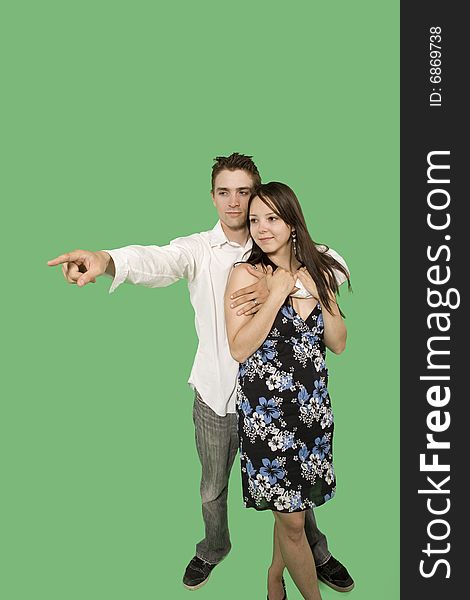 Couple looking at imaginary point over green screen. Couple looking at imaginary point over green screen