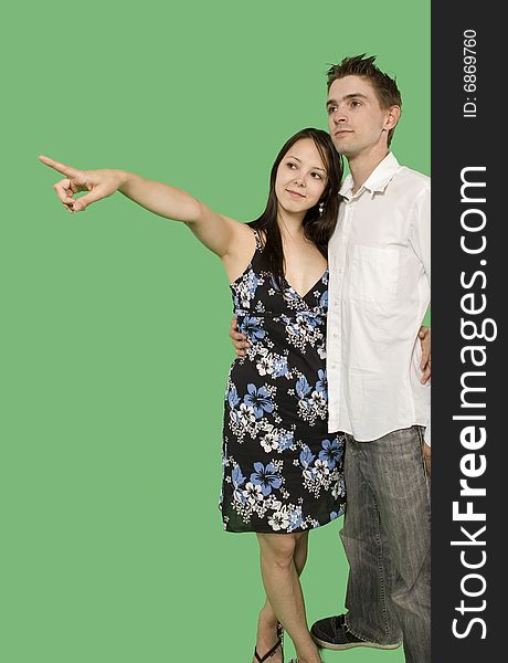 Couple looking at imaginary point over green screen. Couple looking at imaginary point over green screen