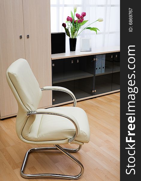 Modern leather armchair on a background of a window