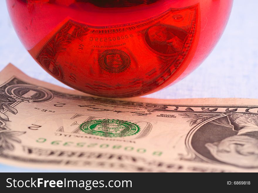 Reflection of the dollar in a glass ball.  Focus foreground glass. Reflection of the dollar in a glass ball.  Focus foreground glass