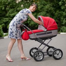 Woman With Baby Carriage Stock Photo