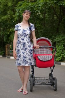 Woman With Baby Carriage Stock Photos