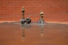Brass Chess Figures On Reflective Surface Stock Photography