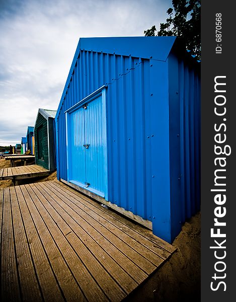 Colourful beach huts on the coastline with dramatic sky. Colourful beach huts on the coastline with dramatic sky