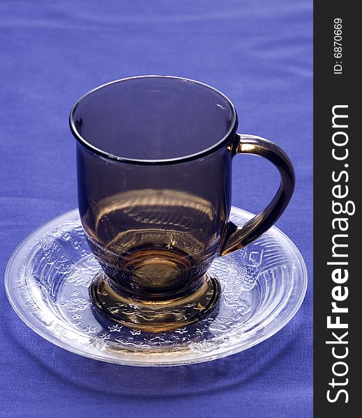 Coffee cup and saucer on blue background