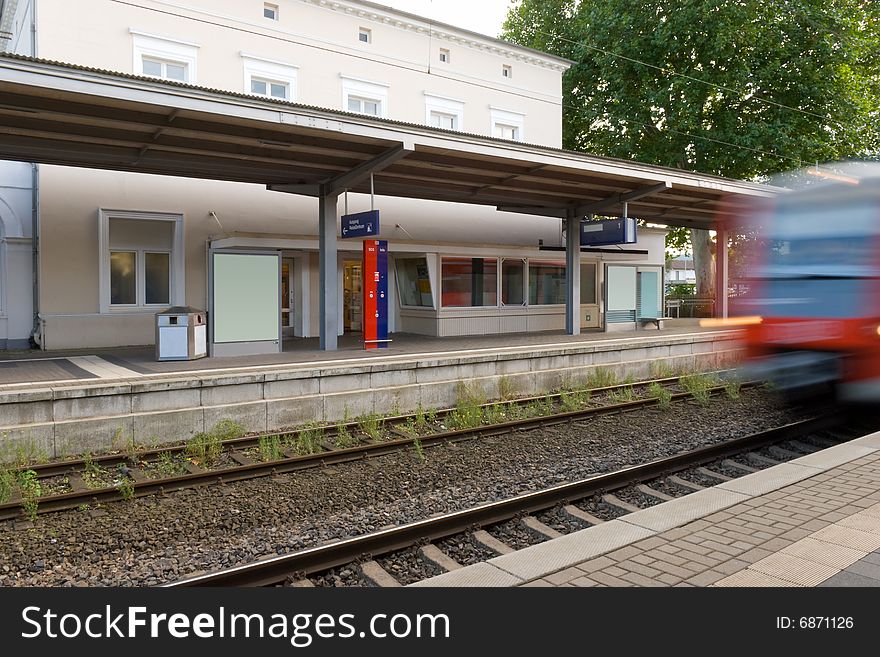 Small railway station with a moving train