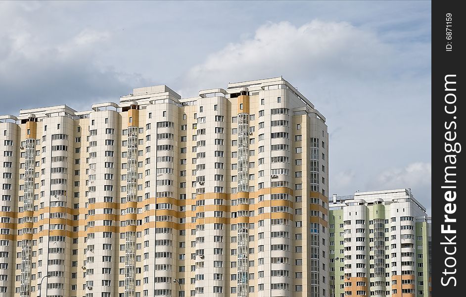 Two multistory residential houses against cloudy sky. Two multistory residential houses against cloudy sky