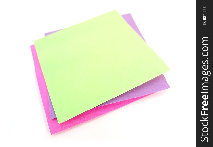 Green, pink and purple sticky notes over white background
