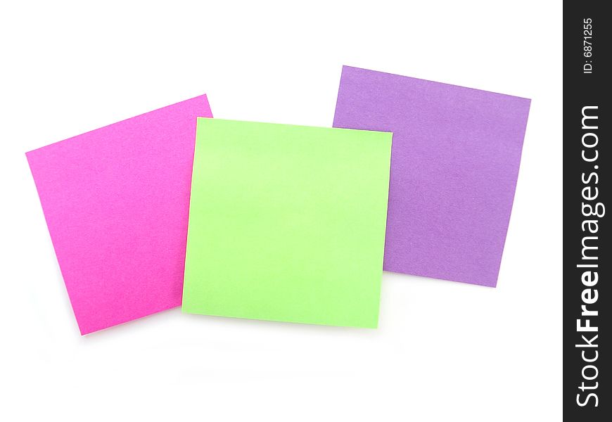 Green, pink and purple sticky notes over white background