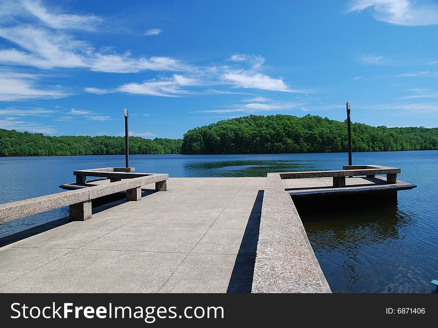 Concrete Dock In Calm Blue Lake