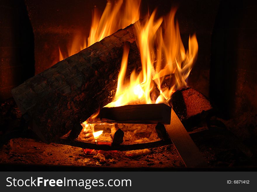 Burning wood with beautiful flames in a fireplace.