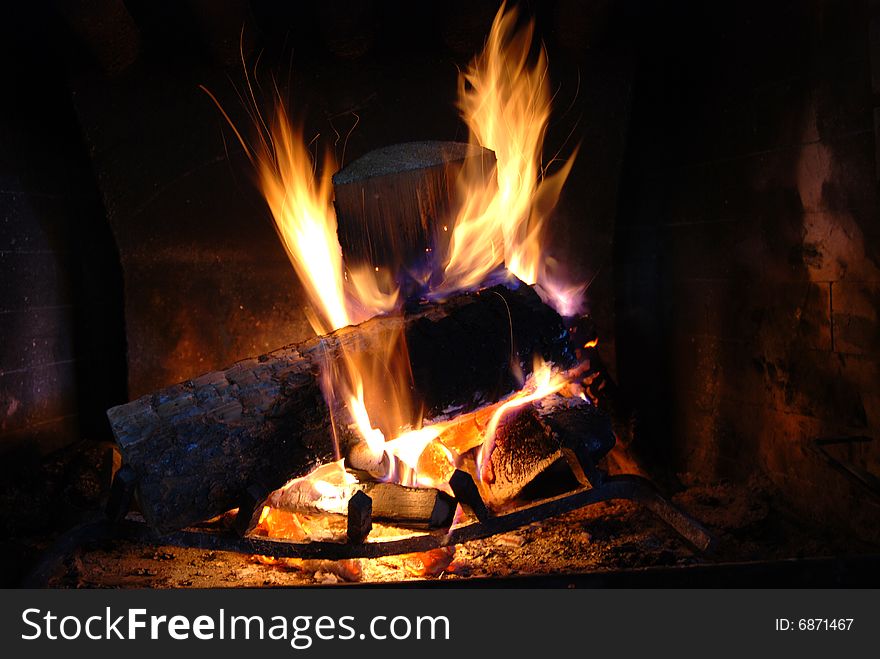 Burning wood with beautiful flames in a fireplace.