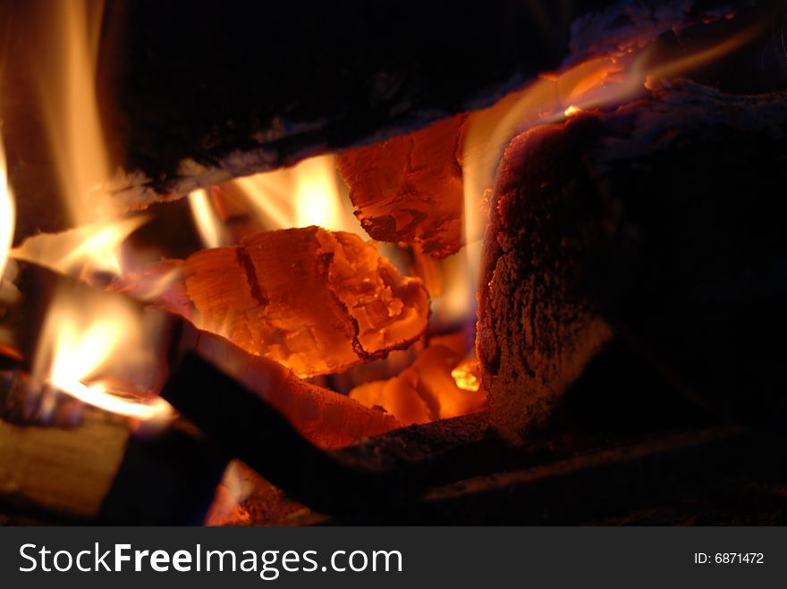 Burning wood with beautiful flames in a fireplace.