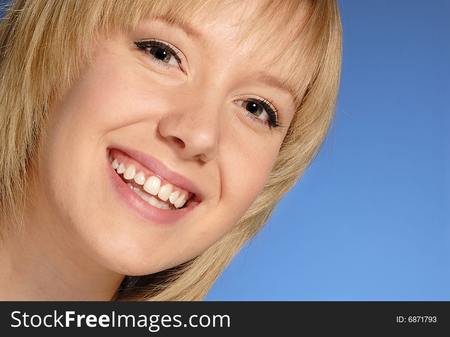 Close up portrait of cute young lady against blue background. Close up portrait of cute young lady against blue background