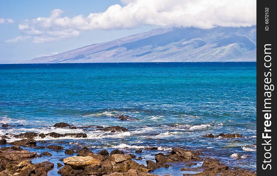 View of the ocean with mountains, clouds, blue sky and turquoise water, from somewhere in Maui, Hawaii. View of the ocean with mountains, clouds, blue sky and turquoise water, from somewhere in Maui, Hawaii.