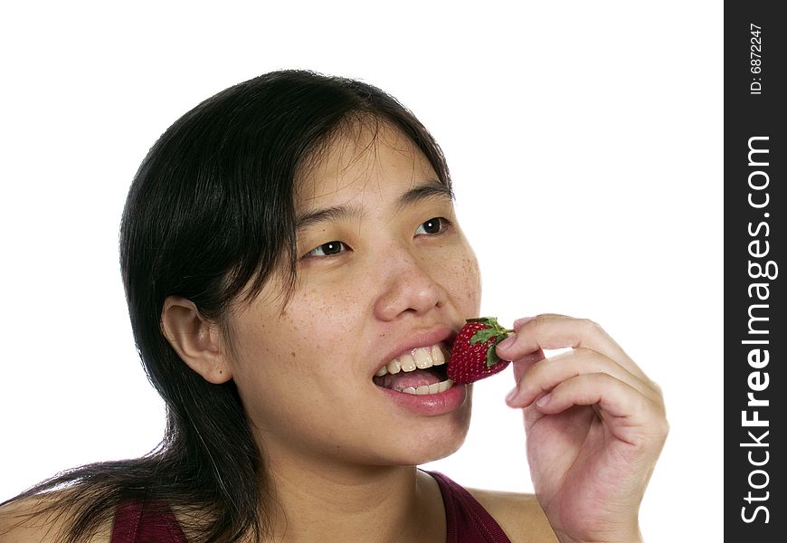 A woman eat strawberry with white background. A woman eat strawberry with white background