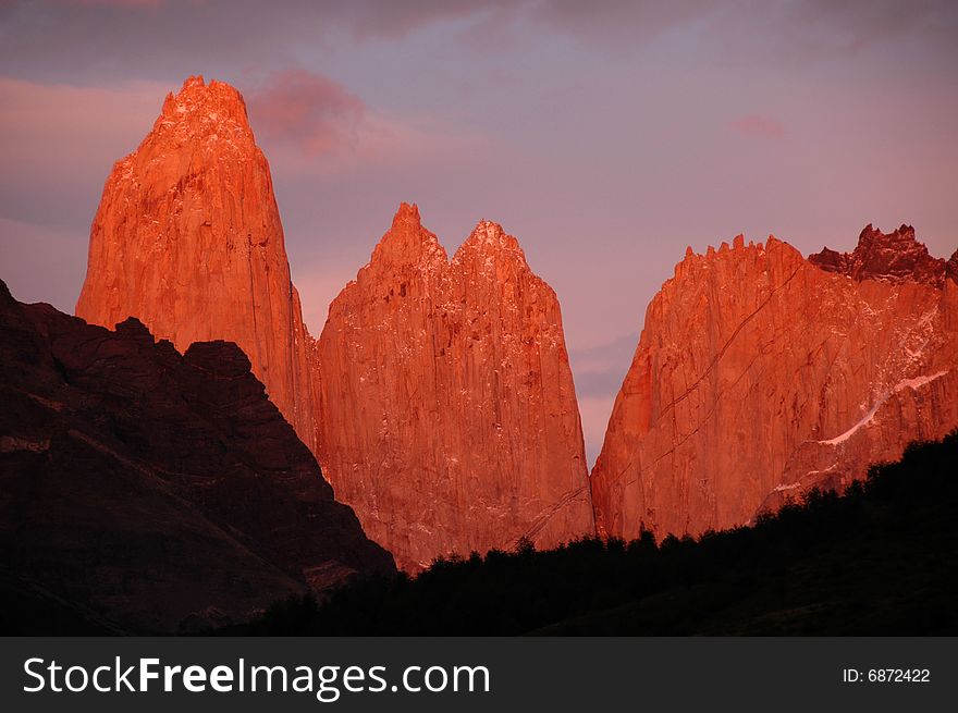 The first sun hits the Torres del Paine and for a few brief minutes the towers reflect the pink light of the morning. The first sun hits the Torres del Paine and for a few brief minutes the towers reflect the pink light of the morning.