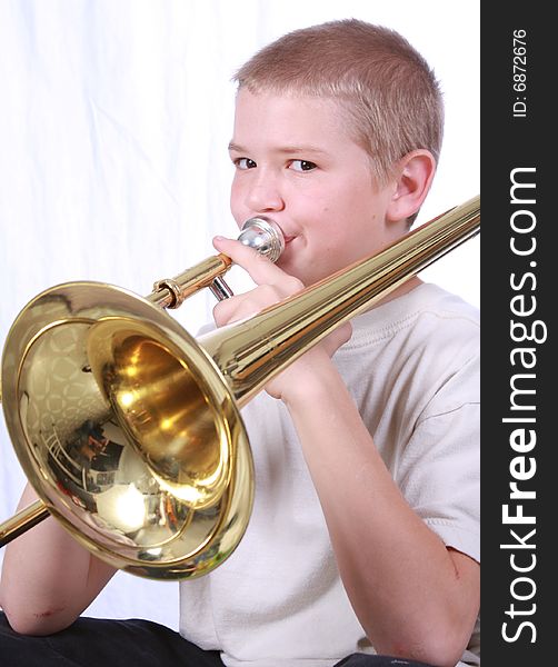 Young boy playing the trombone. Young boy playing the trombone
