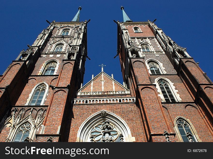 Poland, Wroclaw - old town with most famous and biggest cathedral. Front side with two amazing towers in gothic style. Poland, Wroclaw - old town with most famous and biggest cathedral. Front side with two amazing towers in gothic style.