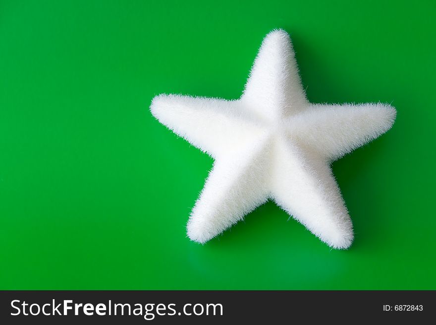 Christmas star with a white star on green background