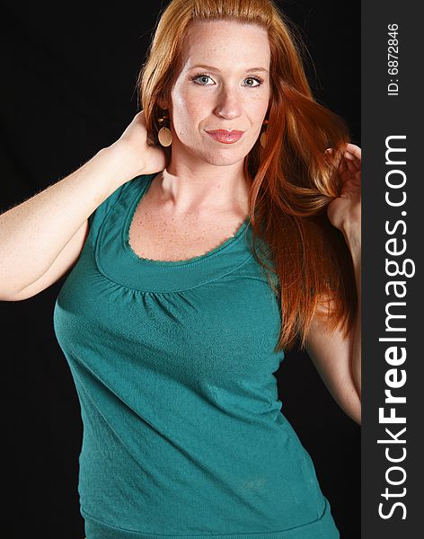 Model standing with slight turn of body with her red hair pulled to one side. Model standing with slight turn of body with her red hair pulled to one side.