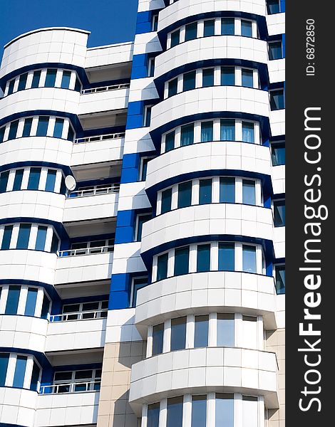 Blue and white building on clear blue sky