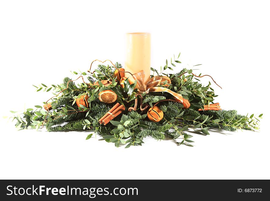 Oranges and cinnamon Christmas table decoration with candle
