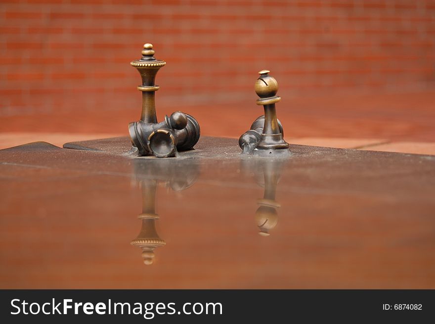 Brass chess figures taken in Portland Oregon's town square. Brass chess figures taken in Portland Oregon's town square