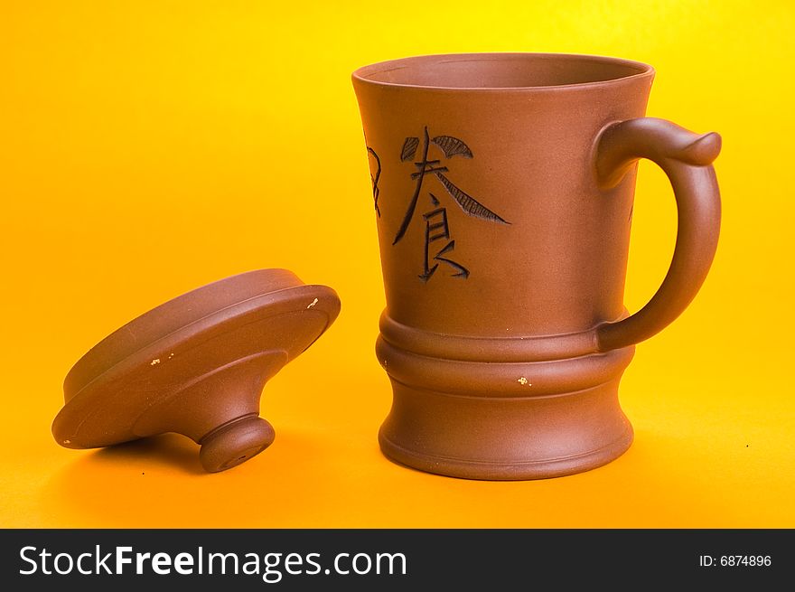 East cup with a lid for tea on a yellow background