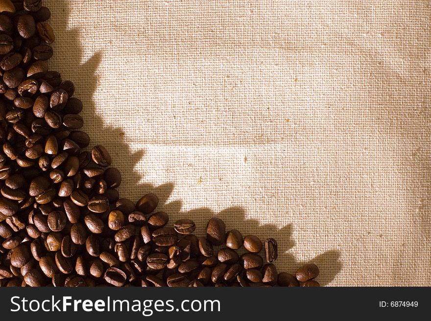 Coffee grains on a sackcloth with hard shade