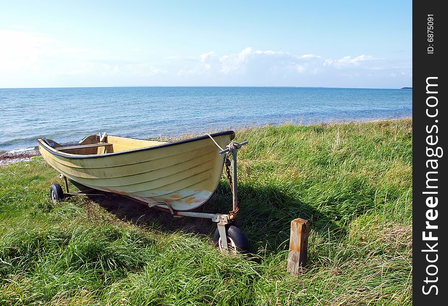 Beach landscape - small colorful skiff on the sand. Beach landscape - small colorful skiff on the sand