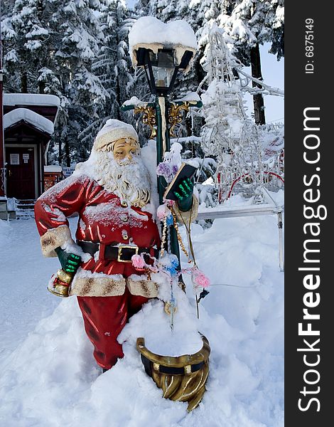 Santa Claus lamp standing in deep snow. Santa Claus lamp standing in deep snow