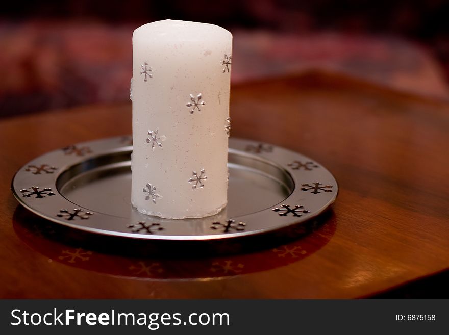 Single christmas white wax candle on table. Single christmas white wax candle on table