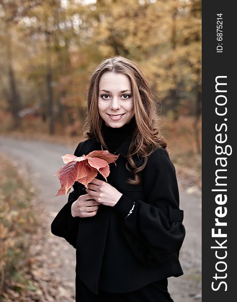 Portrait of smiling beauty young girl in autumn forest. Portrait of smiling beauty young girl in autumn forest.