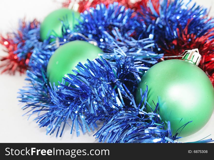 Green, red, dark blue ornaments on a New Year tree. Green, red, dark blue ornaments on a New Year tree