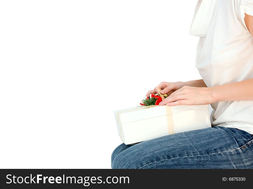 Young beautiful woman opening a box with present