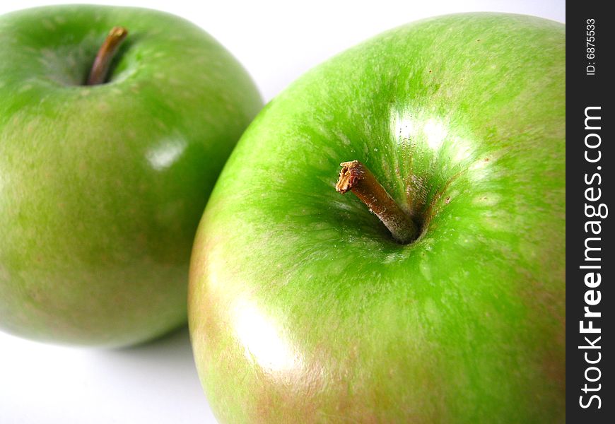 A pair of Granny Smith apples on a white background. A pair of Granny Smith apples on a white background