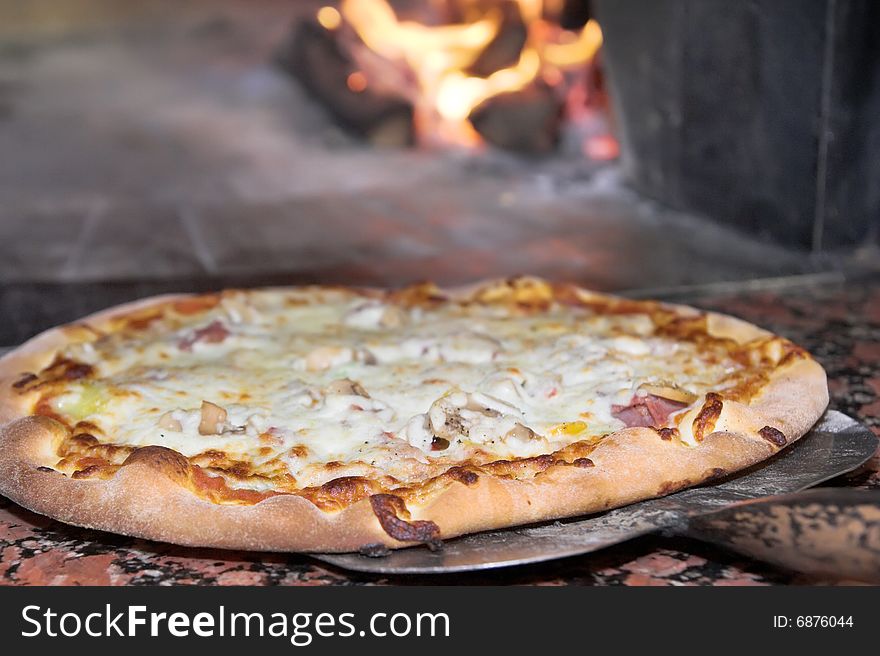 Fresh Pizza, oven or stoven at background. Fresh Pizza, oven or stoven at background