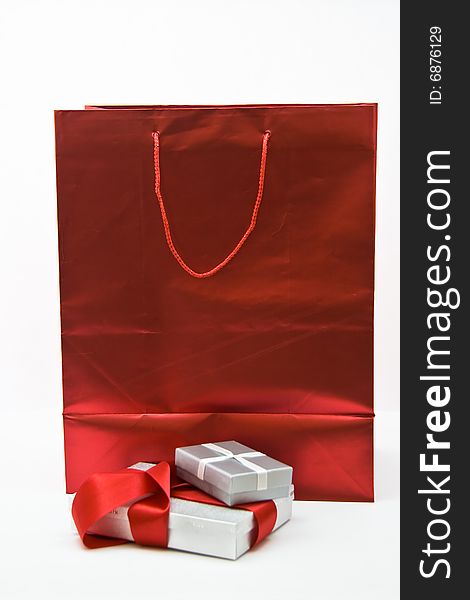 Red gift bag with gift boxes and red ribbon. Red gift bag with gift boxes and red ribbon