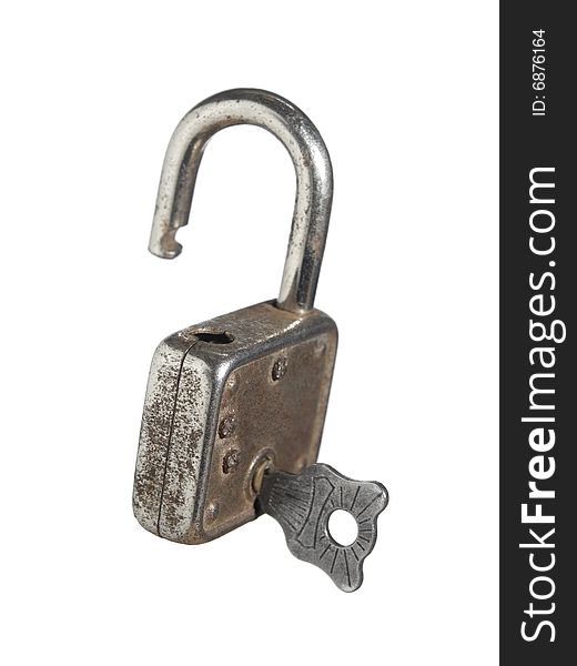 An open lock with a key isolated on white background. An open lock with a key isolated on white background.