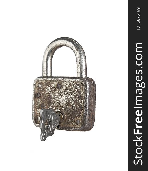 A closed lock with a key isolated on white background. A closed lock with a key isolated on white background.