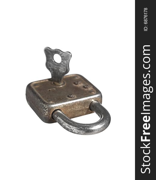 A closed lock with a key isolated on white background. A closed lock with a key isolated on white background.