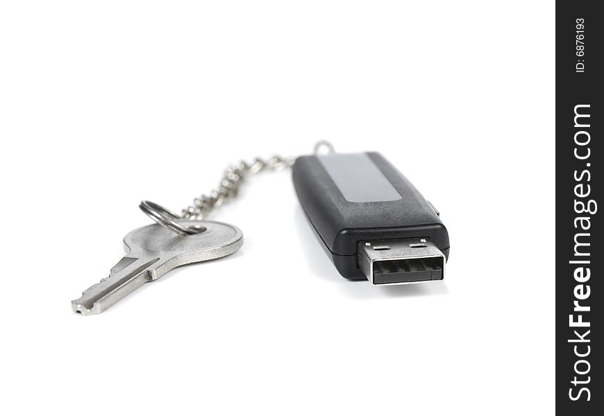 A pendrive keyring with a key over a white background.