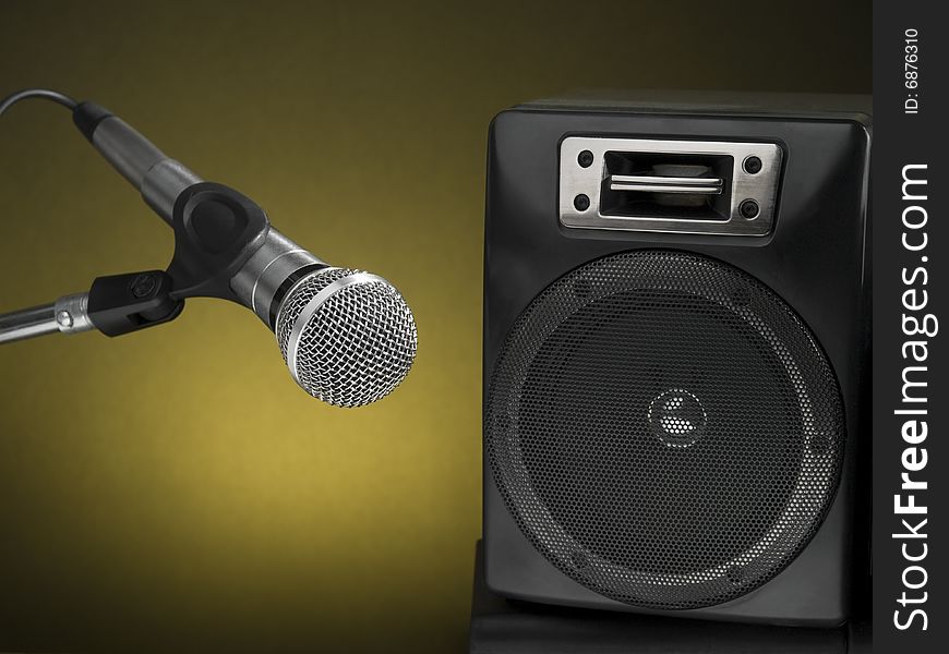 Professional microphone and speaker with a diffuse yellow background. Professional microphone and speaker with a diffuse yellow background.
