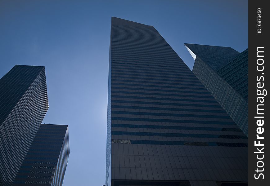 High modern skyscrapers on a background of a blue sky. High modern skyscrapers on a background of a blue sky.