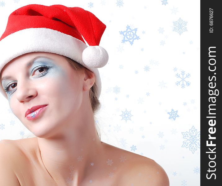 Young beautiful woman in a santa hat with winter make-up. Young beautiful woman in a santa hat with winter make-up
